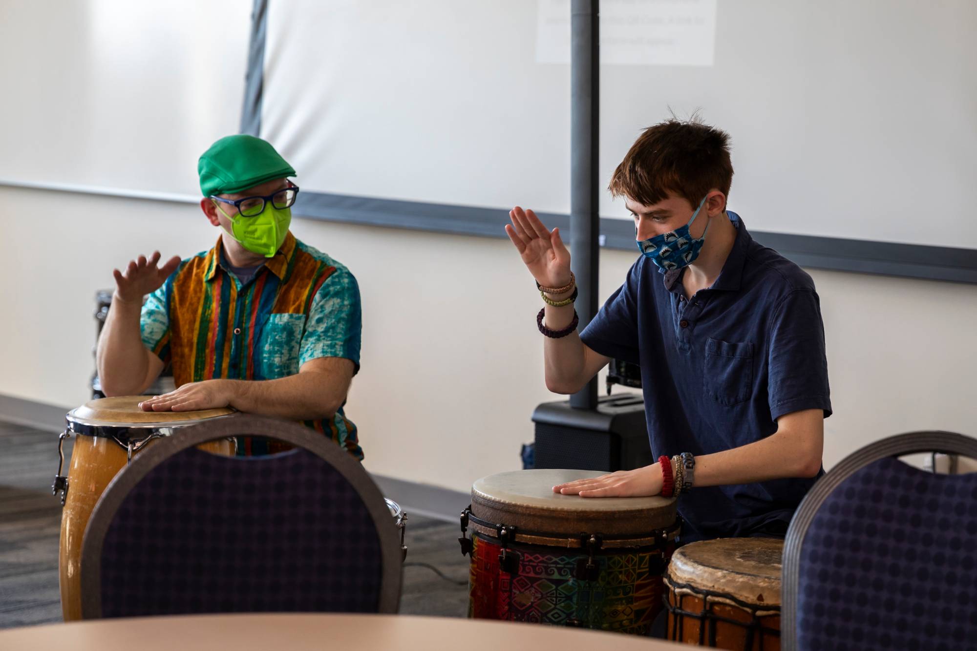 Two campus link members playing drums